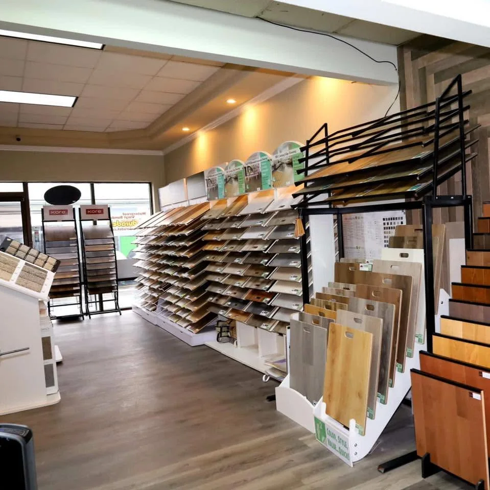 Wide view of the JRC Flooring showroom floor with sample racks.