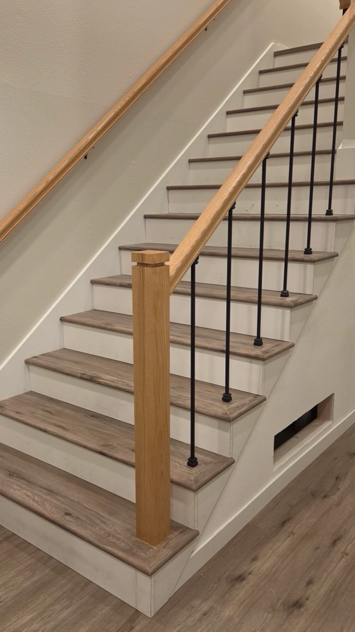 Finished stair treads and railing detail by JRC Flooring.